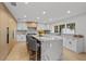 Modern kitchen with white cabinets, a large island, and quartz countertops at 7 1 St Ct, Windermere, FL 34786