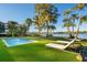 Relaxing pool area with lake view and lounge chairs at 7 1 St Ct, Windermere, FL 34786