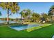 Inviting pool with lush landscaping and lake view at 7 1 St Ct, Windermere, FL 34786