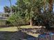 Fenced backyard with lush landscaping and trees at 71 Brooks Dr, Ormond Beach, FL 32176