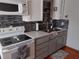 Bright and updated kitchen with white cabinets and gray lower cabinets at 71 Brooks Dr, Ormond Beach, FL 32176