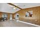 Open living area with wood-paneled walls and view to kitchen at 712 Jason Dr, Lady Lake, FL 32159