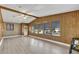 Living room with wood paneling and multiple windows at 712 Jason Dr, Lady Lake, FL 32159