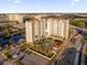 Aerial view of a modern apartment building with pool and parking at 7383 Universal Blvd # 207, Orlando, FL 32819