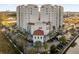 Spectacular aerial view of two condo towers, surrounded by lush greenery and a tranquil lake at 7383 Universal Blvd # 207, Orlando, FL 32819