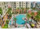 Aerial view showcasing the beautiful pool surrounded by lush landscaping and modern buildings at 7383 Universal Blvd # 207, Orlando, FL 32819