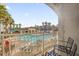 Relaxing balcony view overlooking a community pool with palm trees and lounge chairs at 7383 Universal Blvd # 207, Orlando, FL 32819