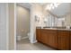 Bathroom features a granite-topped vanity and modern fixtures at 7383 Universal Blvd # 207, Orlando, FL 32819