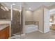 Bathroom showcases a separate glass shower and a soaking tub at 7383 Universal Blvd # 207, Orlando, FL 32819