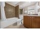 Cozy bathroom with a shower and tub combination, tiled walls, and classic vanity at 7383 Universal Blvd # 207, Orlando, FL 32819