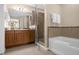 Bathroom showcases a separate glass shower and a soaking tub at 7383 Universal Blvd # 207, Orlando, FL 32819