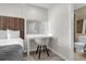 Modern bedroom with a vanity and chair, plus a connecting bathroom, creating a functional space at 7383 Universal Blvd # 207, Orlando, FL 32819