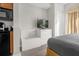 Modern bedroom featuring a flat-screen TV, crisp white dresser, and sleek, minimalist design at 7383 Universal Blvd # 207, Orlando, FL 32819