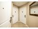 Hallway with two apartment doors and a mirror at 7383 Universal Blvd # 207, Orlando, FL 32819