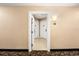 Well-lit hallway with neutral tones, carpeted floors, and multiple doorways at 7383 Universal Blvd # 207, Orlando, FL 32819