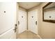 Hallway featuring neutral walls, tile floors, and multiple doors with modern hardware at 7383 Universal Blvd # 207, Orlando, FL 32819