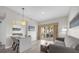 Bright living room with a balcony, a comfortable couch, and a modern dining area at 7383 Universal Blvd # 207, Orlando, FL 32819