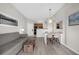 Open living room with comfortable gray sofa, dining table, and view into the kitchen at 7383 Universal Blvd # 207, Orlando, FL 32819