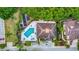 Aerial view of the clubhouse featuring a pool, parking, and lush landscaping at 7615 Bay Port Rd # 36, Orlando, FL 32819