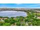 Aerial view of a home and neighborhood surrounded by lush trees and a scenic lake at 7615 Bay Port Rd # 36, Orlando, FL 32819