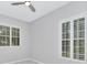 Bright bedroom with grey walls, white shutters, and ceiling fan at 7615 Bay Port Rd # 36, Orlando, FL 32819