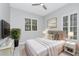 This bedroom features natural light, a ceiling fan, and a soft, neutral color palette at 7615 Bay Port Rd # 36, Orlando, FL 32819