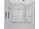 Bedroom with grey walls, white doors, and white tile floor at 7615 Bay Port Rd # 36, Orlando, FL 32819