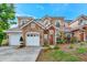 Two-story stucco home with stone accents, two-car garage, and landscaped yard at 7615 Bay Port Rd # 36, Orlando, FL 32819