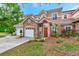 Two-story stucco home with stone accents, two-car garage, and landscaped yard at 7615 Bay Port Rd # 36, Orlando, FL 32819