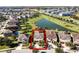 Aerial view highlighting a home's location near a pond at 7654 Wilmington Loop, Kissimmee, FL 34747