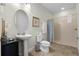 Bathroom with pedestal sink, toilet and shower at 7654 Wilmington Loop, Kissimmee, FL 34747