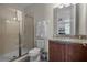 Clean bathroom with a shower, toilet, and granite vanity at 7654 Wilmington Loop, Kissimmee, FL 34747