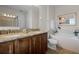 Double vanity bathroom with granite countertops and soaking tub at 7654 Wilmington Loop, Kissimmee, FL 34747