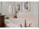 Relaxing bathroom with a large garden tub and neutral tile at 7654 Wilmington Loop, Kissimmee, FL 34747