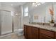 Elegant bathroom with granite vanity and walk-in shower at 7654 Wilmington Loop, Kissimmee, FL 34747