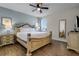 Bright bedroom with a king-size bed and ceiling fan at 7654 Wilmington Loop, Kissimmee, FL 34747