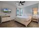 Spacious bedroom with a king-size bed and wood floors at 7654 Wilmington Loop, Kissimmee, FL 34747