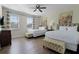 Spacious bedroom with two queen beds, ample natural light, and wood floors at 7654 Wilmington Loop, Kissimmee, FL 34747