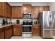 Modern kitchen with stainless steel appliances and granite countertops at 7654 Wilmington Loop, Kissimmee, FL 34747