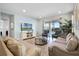 Living room with comfortable sofas, a large TV, and sliding glass doors leading to a patio at 7654 Wilmington Loop, Kissimmee, FL 34747