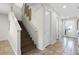 Modern staircase with wood steps and white railings in a light-colored home at 7654 Wilmington Loop, Kissimmee, FL 34747