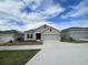 New single-story home with attached garage and neutral exterior at 807 Ofanto Way, Haines City, FL 33844