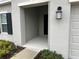 Inviting front porch entryway with light fixture at 807 Ofanto Way, Haines City, FL 33844