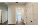 Bright hallway with wood-look flooring and neutral walls at 807 Ofanto Way, Haines City, FL 33844