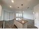 Open kitchen features a large island and breakfast bar at 807 Ofanto Way, Haines City, FL 33844