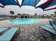 Community pool with lounge chairs and shade at 807 Ofanto Way, Haines City, FL 33844