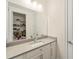 Bathroom with vanity, large mirror, and access to closet at 8558 Morehouse Dr, Orlando, FL 32836