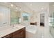 Luxurious bathroom with double vanity and soaking tub at 8558 Morehouse Dr, Orlando, FL 32836