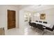 Modern dining room with a large table, chandelier, and hardwood floors at 8558 Morehouse Dr, Orlando, FL 32836