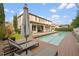 Relaxing pool area with deck, lounge chairs and umbrella at 8558 Morehouse Dr, Orlando, FL 32836